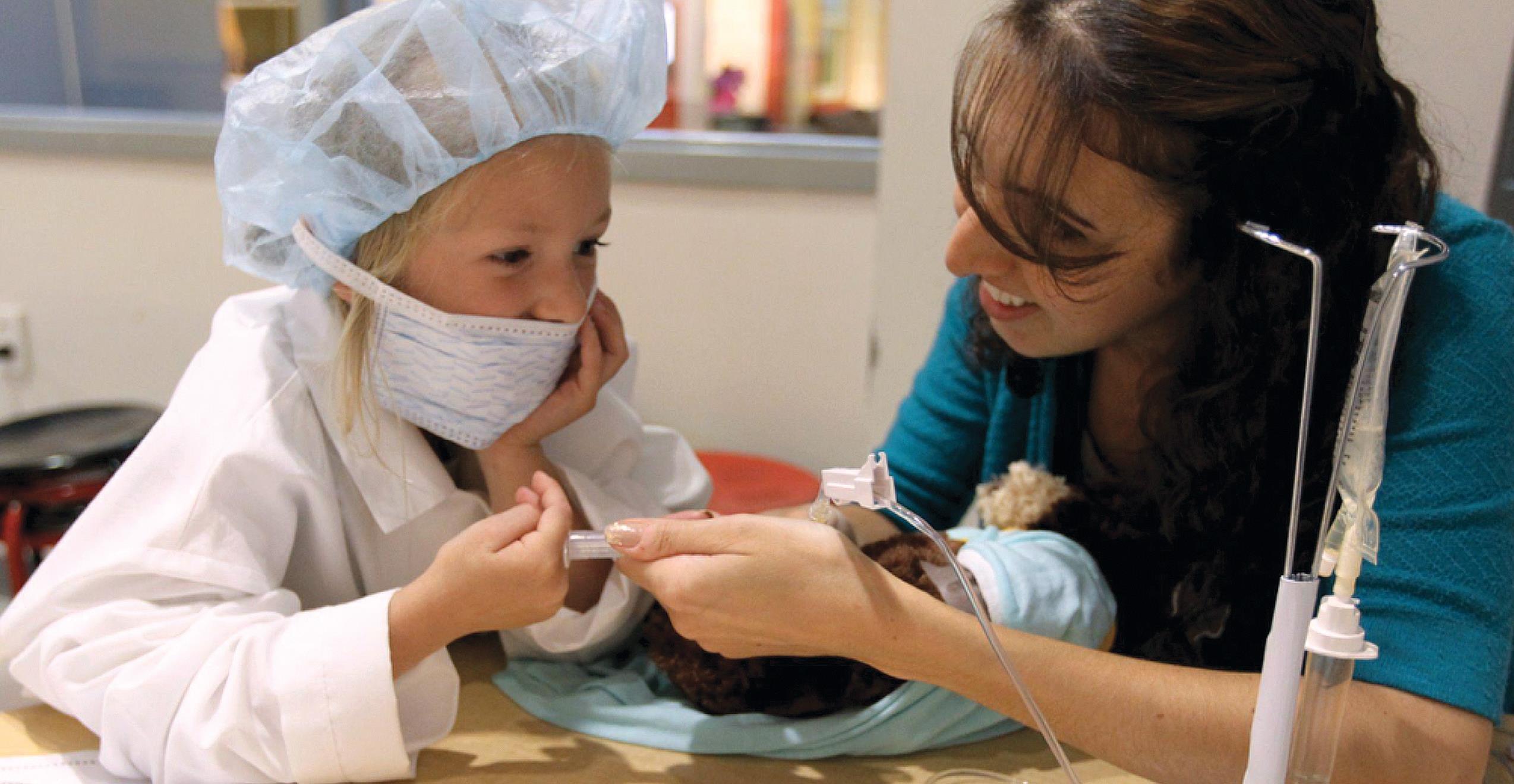 Child life fellow and child interacting