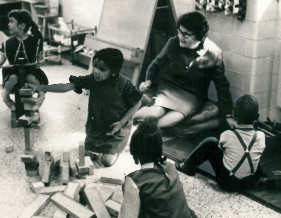 Emma Plank with children in a hospital playroom